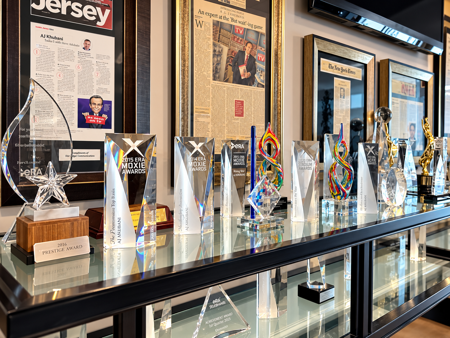 Trophies and framed honors from AJ Khubani’s awards collection